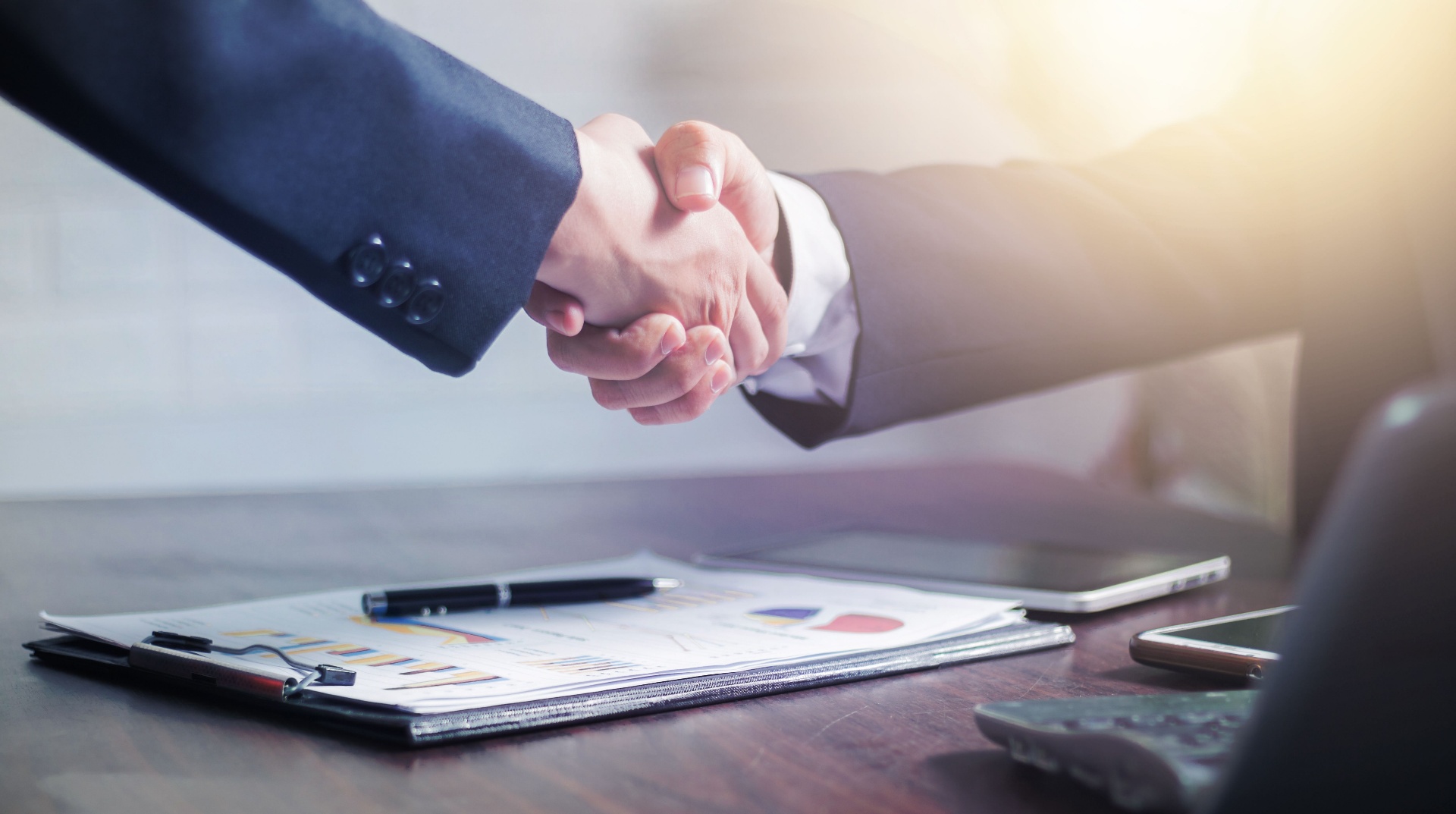 Business handshake over consulting documents